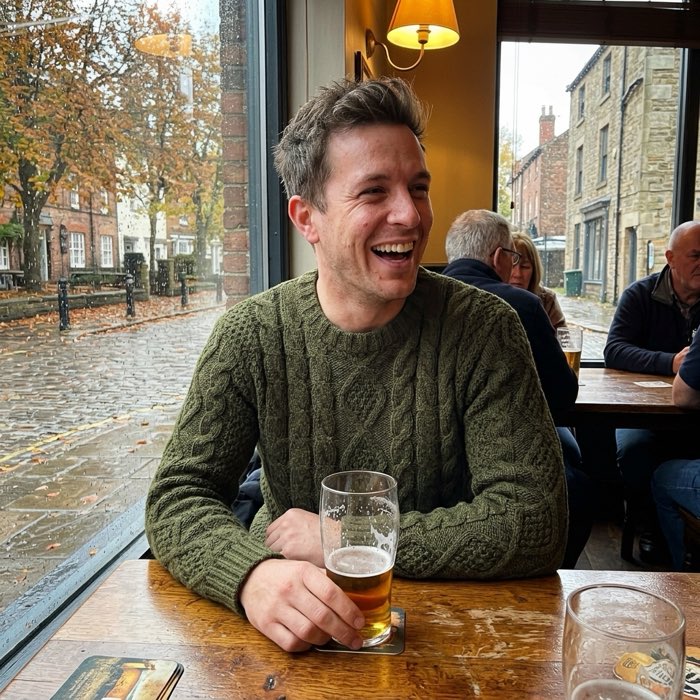 Man in a cable-knit crew neck sweater in a pub